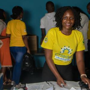 Smiling young woman in a yellow shirt